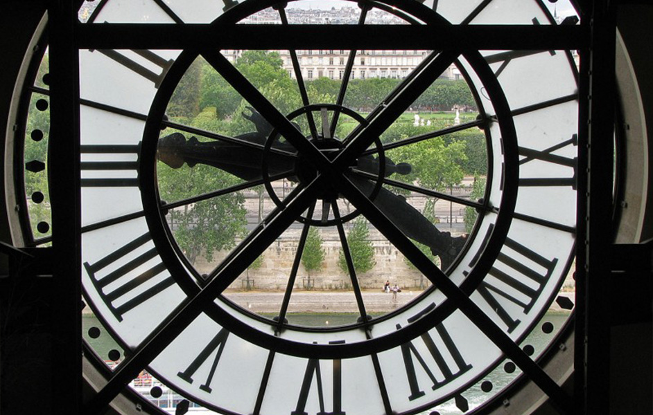 View of Paris through the giant clock at the Musée d'Orsay, a popular feature of the museum's architecture.